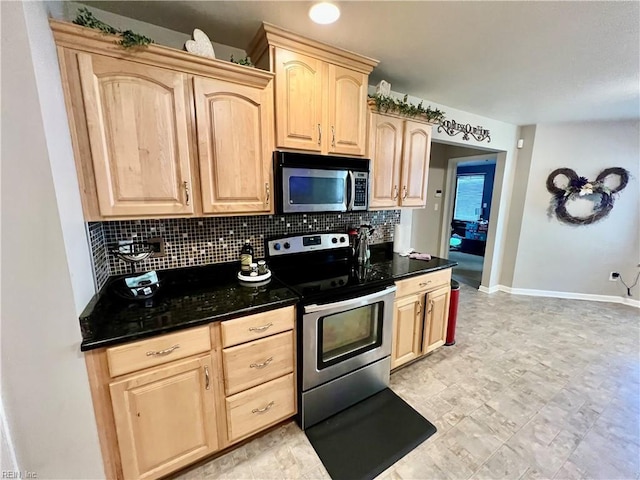 kitchen with appliances with stainless steel finishes, light brown cabinetry, backsplash, and baseboards