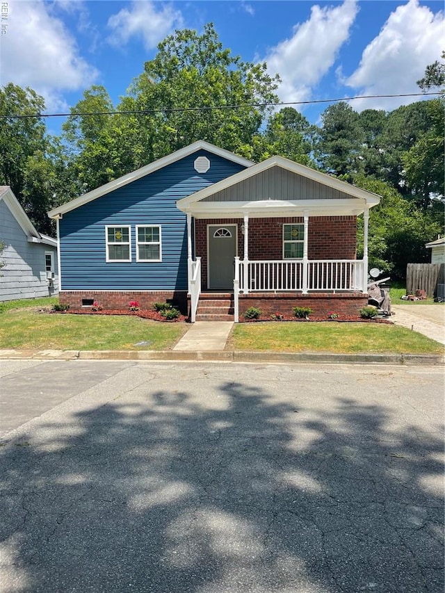 712 Norfleet St, Franklin, VA 23851 - view of front of home with a porch and brick siding