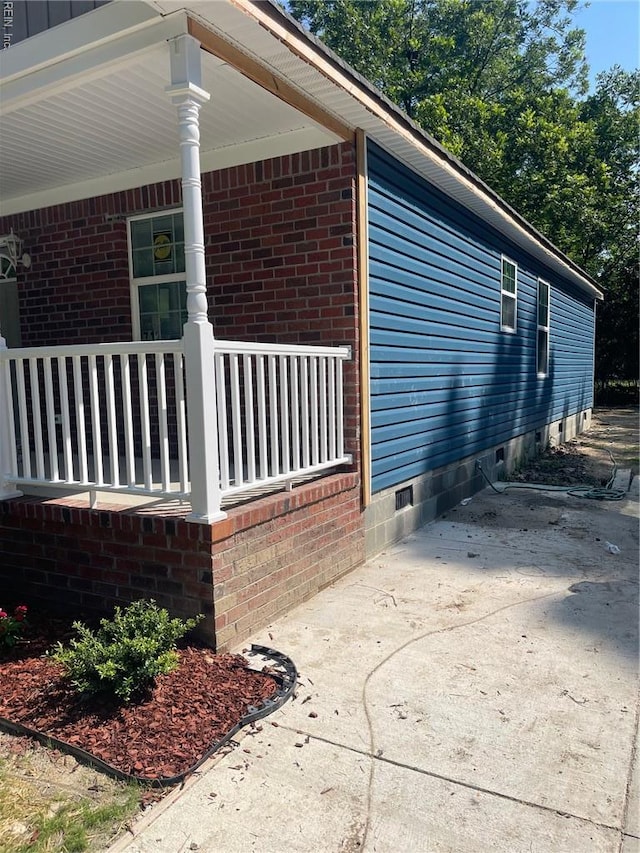 712 Norfleet St, Franklin, VA 23851 - view of property exterior featuring a porch, crawl space, and brick siding