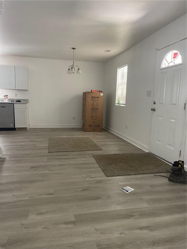 712 Norfleet St, Franklin, VA 23851 - entrance foyer with baseboards, light wood finished floors, and a chandelier