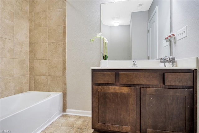 613 Freeman Dr, Hampton, VA 23666 - bathroom featuring a tub, vanity, baseboards, and a textured wall