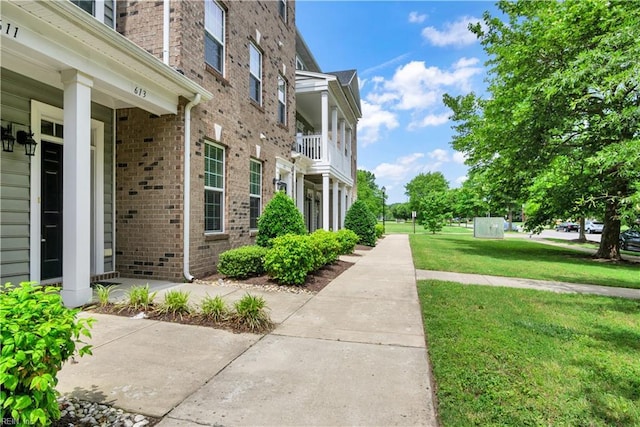 613 Freeman Dr, Hampton, VA 23666 - view of side of home featuring brick siding and a yard