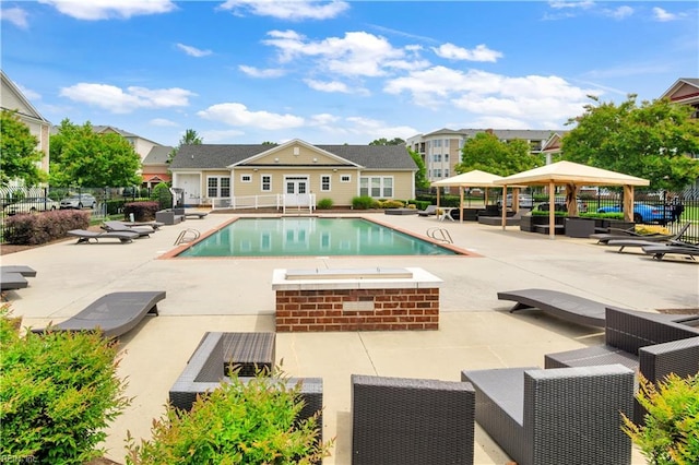 613 Freeman Dr, Hampton, VA 23666 - community pool featuring a gazebo, fence, a patio, an exterior structure, and an outbuilding