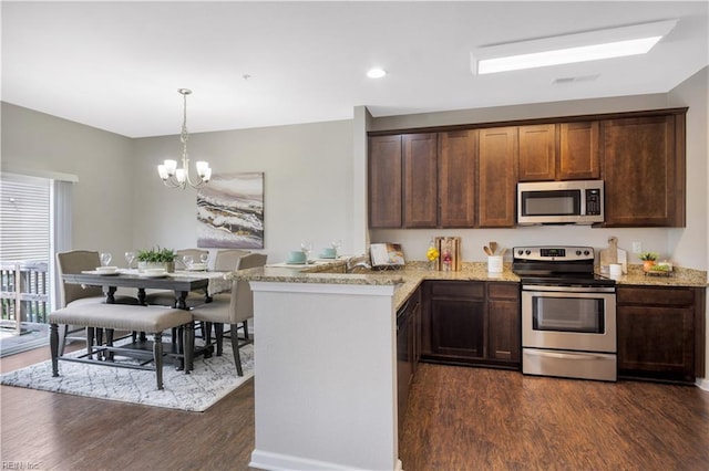 613 Freeman Dr, Hampton, VA 23666 - kitchen with stainless steel appliances, dark wood-style flooring, light stone countertops, a chandelier, and a peninsula