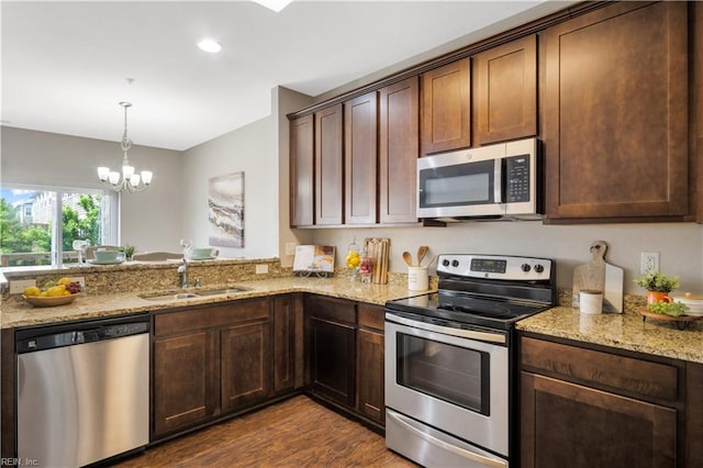 613 Freeman Dr, Hampton, VA 23666 - kitchen with stainless steel appliances, a sink, dark wood-type flooring, light stone countertops, and recessed lighting