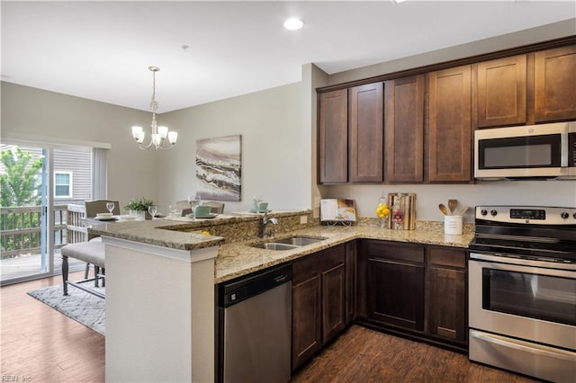 613 Freeman Dr, Hampton, VA 23666 - kitchen with appliances with stainless steel finishes, a sink, a peninsula, dark wood-style floors, and a chandelier