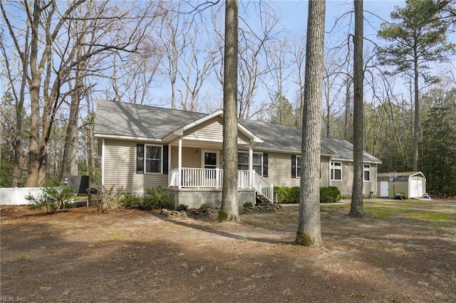 28111 Harbor Rd, Melfa, VA 23410 - ranch-style home featuring a porch, a storage shed, and an outdoor structure
