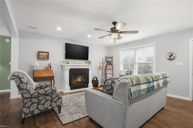 28111 Harbor Rd, Melfa, VA 23410 - living area with dark wood-style floors, a ceiling fan, baseboards, a glass covered fireplace, and recessed lighting