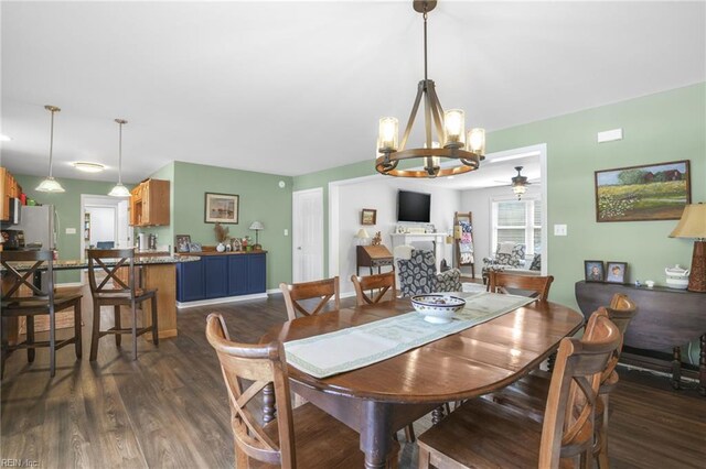 28111 Harbor Rd, Melfa, VA 23410 - dining area with a chandelier, dark wood-style floors, ceiling fan, and baseboards