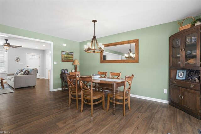 28111 Harbor Rd, Melfa, VA 23410 - dining space with a chandelier, dark wood-style flooring, baseboards, and ceiling fan