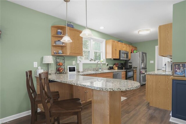 28111 Harbor Rd, Melfa, VA 23410 - kitchen with appliances with stainless steel finishes, a sink, a peninsula, dark wood-style floors, and a kitchen bar