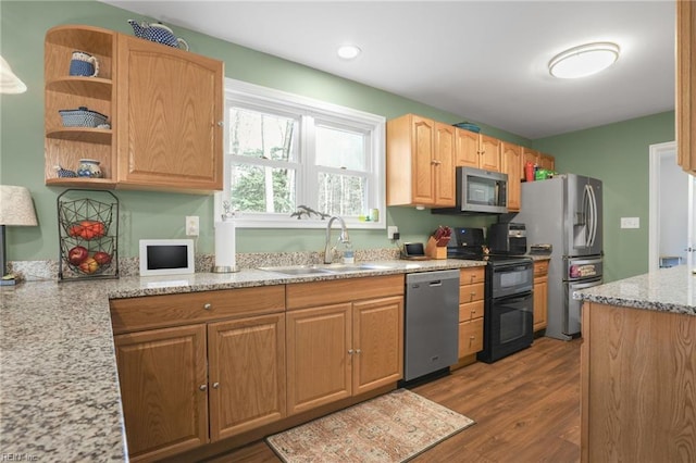 28111 Harbor Rd, Melfa, VA 23410 - kitchen featuring appliances with stainless steel finishes, a sink, wood finished floors, light stone counters, and open shelves