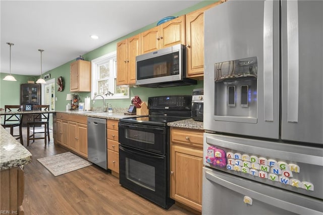 28111 Harbor Rd, Melfa, VA 23410 - kitchen featuring appliances with stainless steel finishes, a sink, dark wood-style floors, hanging light fixtures, and light stone countertops