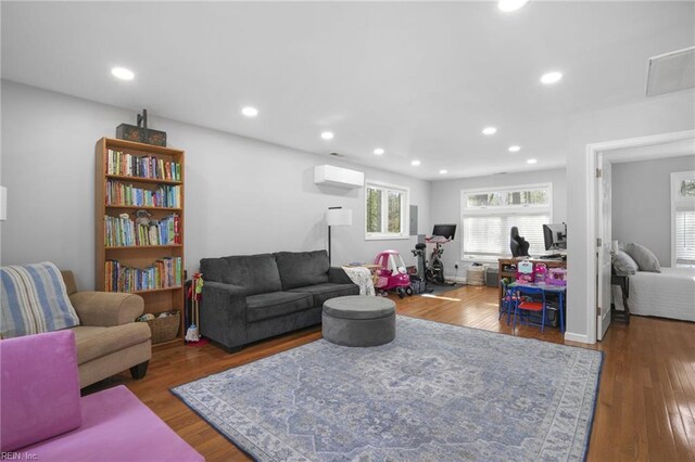 28111 Harbor Rd, Melfa, VA 23410 - living area with wood finished floors, a wall mounted air conditioner, and recessed lighting