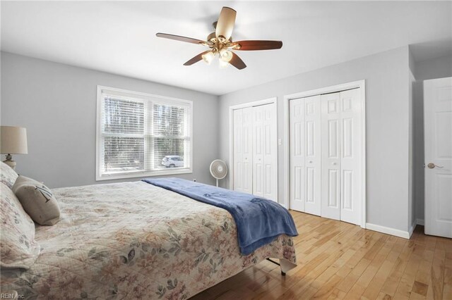28111 Harbor Rd, Melfa, VA 23410 - bedroom featuring two closets, wood-type flooring, baseboards, and a ceiling fan