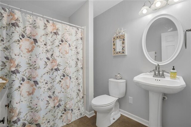 28111 Harbor Rd, Melfa, VA 23410 - full bathroom with toilet, tile patterned floors, a shower with shower curtain, and baseboards