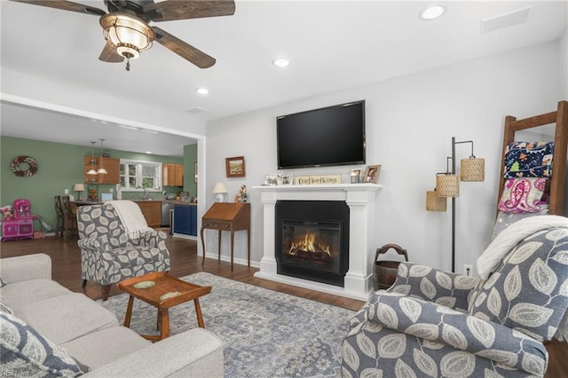 28111 Harbor Rd, Melfa, VA 23410 - living area with ceiling fan, dark wood-type flooring, a glass covered fireplace, and recessed lighting