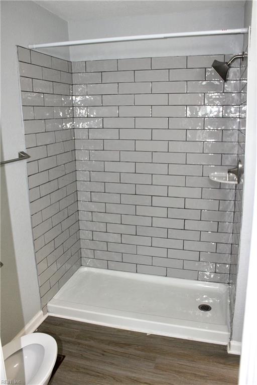 1307 Hibie St, Norfolk, VA 23523 - full bathroom with wood finished floors, a stall shower, and toilet