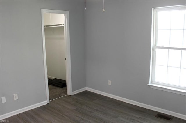 1307 Hibie St, Norfolk, VA 23523 - unfurnished bedroom with a closet, dark wood finished floors, baseboards, and a spacious closet