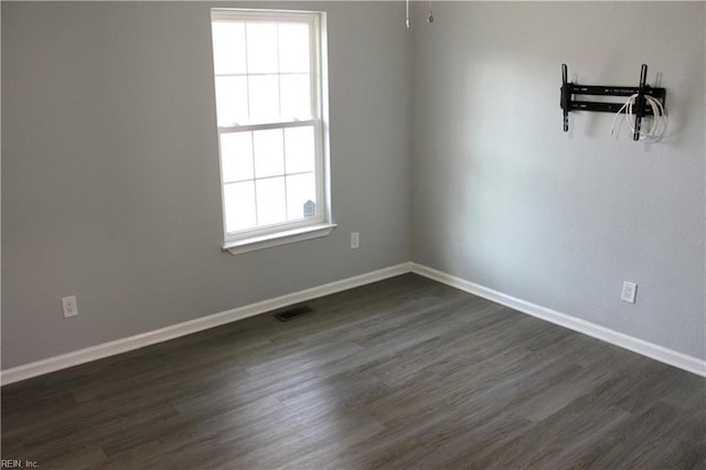 1307 Hibie St, Norfolk, VA 23523 - spare room with baseboards and dark wood-style floors