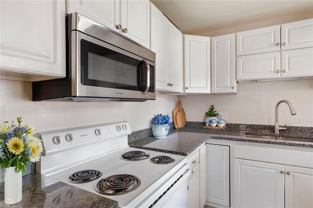 8284 Fernwood Dr, Norfolk, VA 23518 - kitchen featuring electric range, stainless steel microwave, a sink, white cabinetry, and dark stone countertops