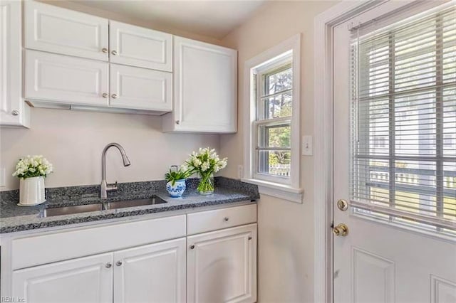 8284 Fernwood Dr, Norfolk, VA 23518 - kitchen featuring a sink, white cabinetry, and dark stone counters