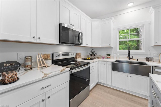 107 Wheeley Cir, Yorktown, VA 23693 - kitchen with stainless steel range with electric cooktop, a sink, white cabinetry, and light wood-style floors