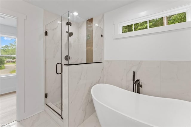 107 Wheeley Cir, Yorktown, VA 23693 - full bathroom with marble tiled floors, a marble finish shower, a freestanding tub, and tile walls