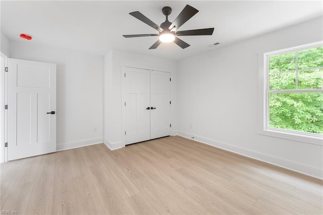 107 Wheeley Cir, Yorktown, VA 23693 - unfurnished bedroom with light wood-style flooring, multiple windows, and baseboards