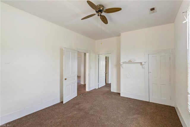 unfurnished bedroom with carpet flooring, a ceiling fan, and baseboards