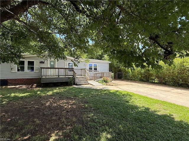 1224 Old Clubhouse Rd, Virginia Beach, VA 23453 - view of green lawn featuring a deck and concrete driveway
