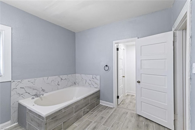 1250 27th St, Newport News, VA 23607 - bathroom with a garden tub and wood finished floors