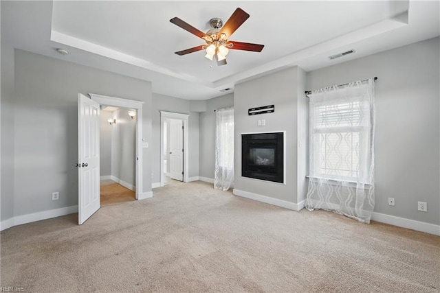 9628 7th Bay St Unit A, Norfolk, VA 23518 - unfurnished living room featuring a tray ceiling, carpet flooring, ceiling fan, and a glass covered fireplace