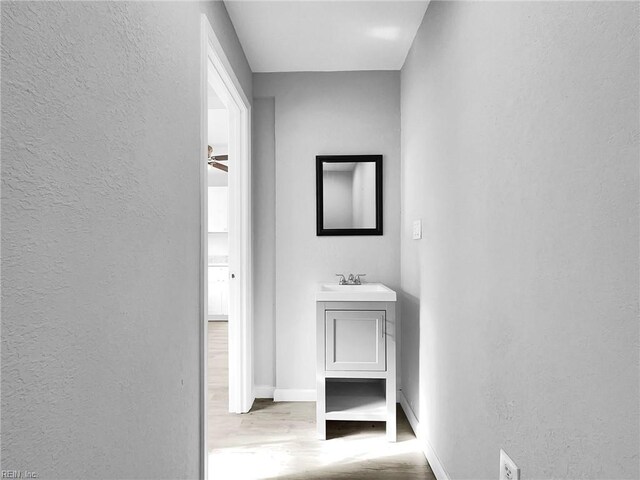 2728 Sewells Point Rd, Norfolk, VA 23513 - bathroom with a textured wall, wood finished floors, baseboards, and vanity