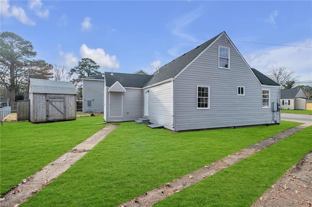 2728 Sewells Point Rd, Norfolk, VA 23513 - rear view of property featuring a storage shed, roof with shingles, a yard, and an outbuilding