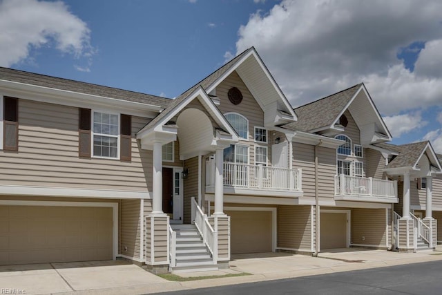 3914 Van Ness Dr, Virginia Beach, VA 23462 - view of front of property featuring a garage, a shingled roof, driveway, and stairway