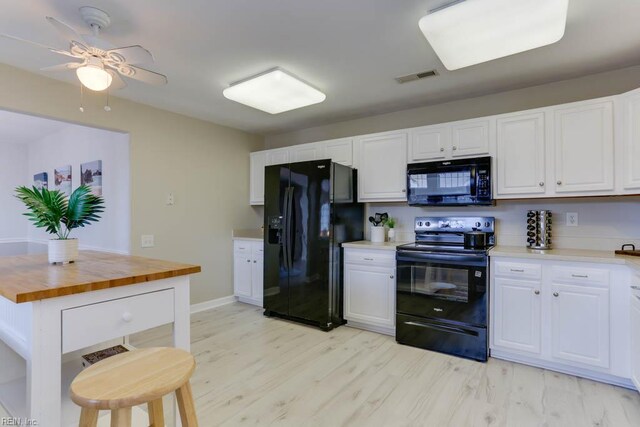 3914 Van Ness Dr, Virginia Beach, VA 23462 - kitchen featuring black appliances, wood counters, white cabinetry, and light wood-style flooring