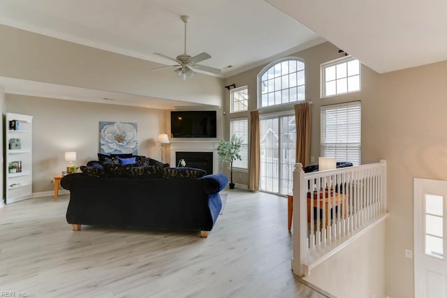 3914 Van Ness Dr, Virginia Beach, VA 23462 - living room featuring ornamental molding, light wood finished floors, a ceiling fan, a fireplace, and baseboards