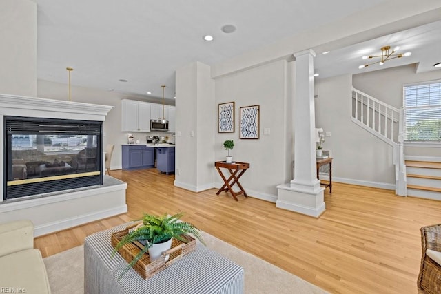 2512 E Ocean View Ave Unit A, Norfolk, VA 23518 - living room featuring light wood-type flooring, stairs, a multi sided fireplace, baseboards, and recessed lighting
