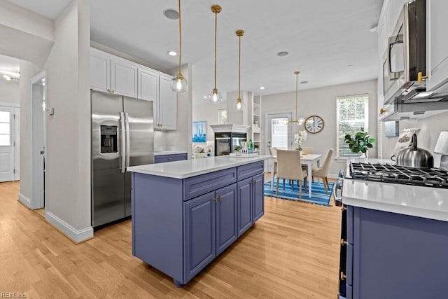 2512 E Ocean View Ave Unit A, Norfolk, VA 23518 - kitchen featuring appliances with stainless steel finishes, blue cabinets, light wood-style flooring, light countertops, and baseboards