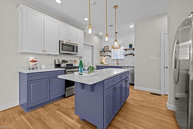 2512 E Ocean View Ave Unit A, Norfolk, VA 23518 - kitchen featuring appliances with stainless steel finishes, blue cabinetry, light countertops, light wood-style floors, and recessed lighting