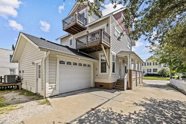 2512 E Ocean View Ave Unit A, Norfolk, VA 23518 - view of front facade featuring a balcony, concrete driveway, a garage, and central AC unit