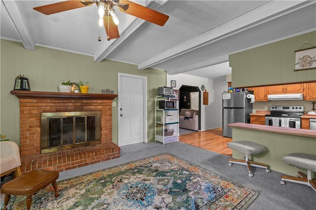 6110 Lyndhurst Ave, Norfolk, VA 23502 - living room featuring light colored carpet, beamed ceiling, a ceiling fan, a textured ceiling, and a brick fireplace