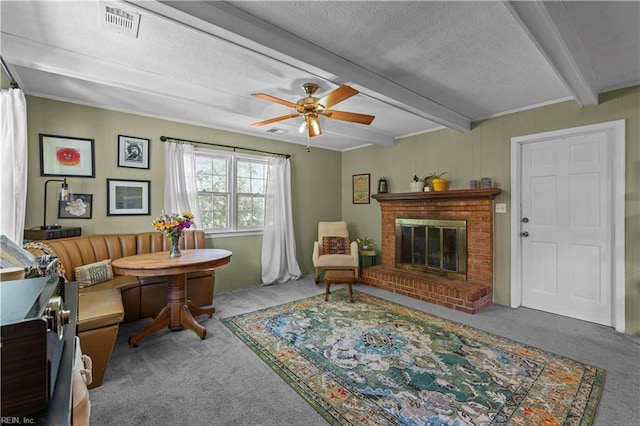 6110 Lyndhurst Ave, Norfolk, VA 23502 - sitting room with carpet floors, beam ceiling, a ceiling fan, a brick fireplace, and a textured ceiling