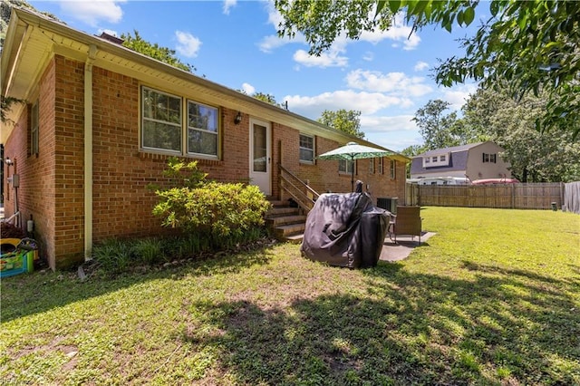 6110 Lyndhurst Ave, Norfolk, VA 23502 - rear view of house featuring entry steps, brick siding, and a patio