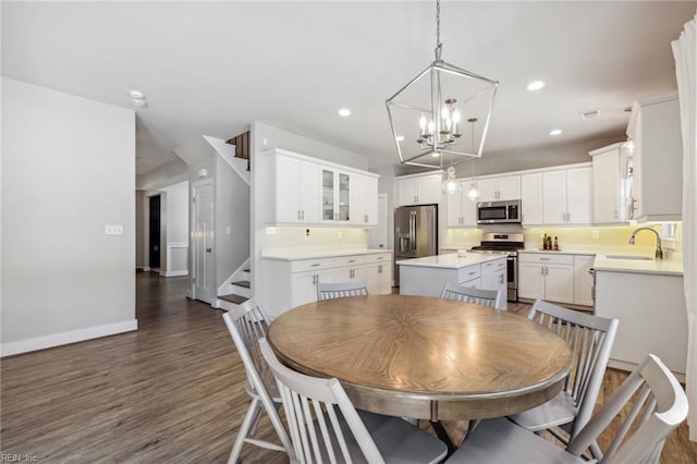 1328 Andreas Ln, Chesapeake, VA 23322 - dining space featuring stairs, a chandelier, baseboards, dark wood-style floors, and recessed lighting