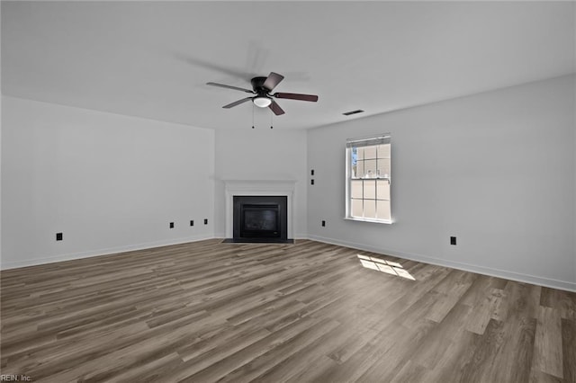 130 Rochdale Ln, Suffolk, VA 23434 - unfurnished living room with ceiling fan, a fireplace with flush hearth, wood finished floors, and baseboards