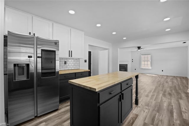 130 Rochdale Ln, Suffolk, VA 23434 - kitchen featuring wooden counters, stainless steel refrigerator with ice dispenser, ceiling fan, white cabinetry, and backsplash