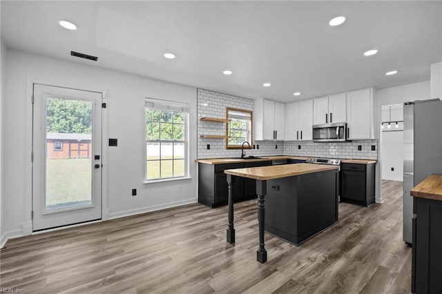 130 Rochdale Ln, Suffolk, VA 23434 - kitchen featuring wooden counters, appliances with stainless steel finishes, a sink, white cabinetry, and recessed lighting