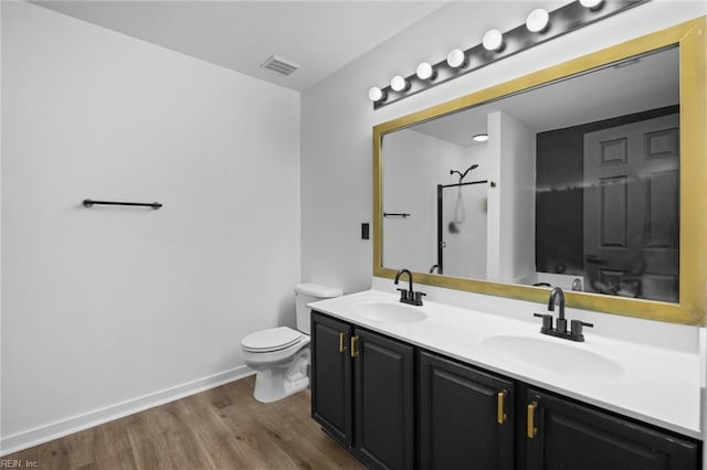 130 Rochdale Ln, Suffolk, VA 23434 - bathroom featuring a shower, toilet, wood finished floors, double vanity, and baseboards
